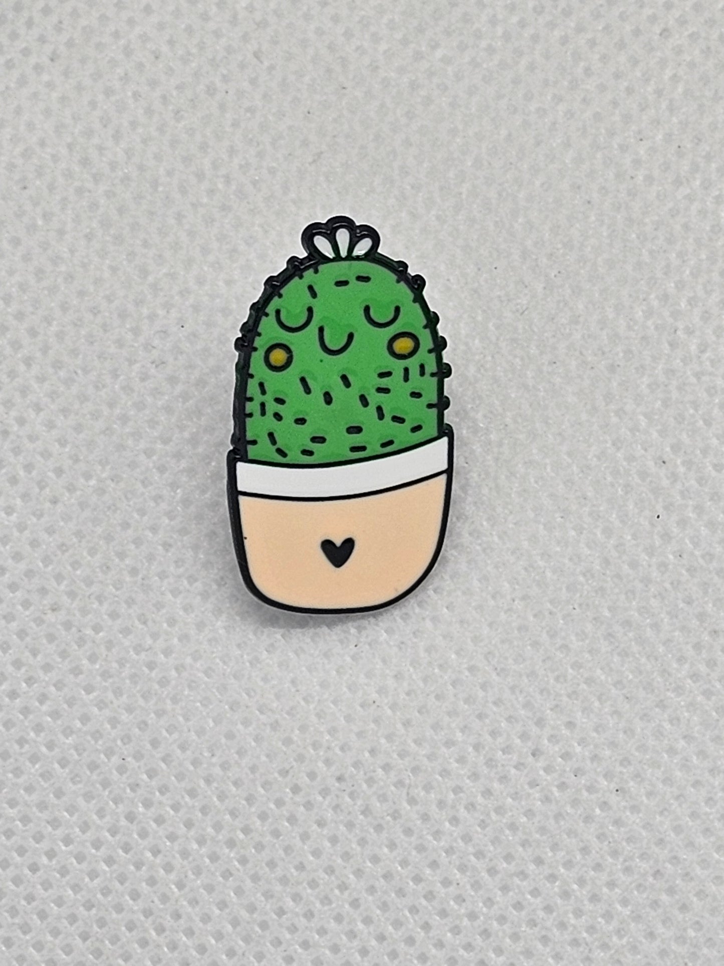 Cute cactus enamel pin badge with a smiling face in a pot, ideal for backpacks or jackets.