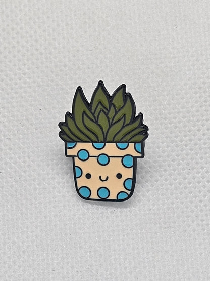 Quirky floral pin badge featuring a smiling plant in a polka-dotted pot, perfect for backpacks and jackets.