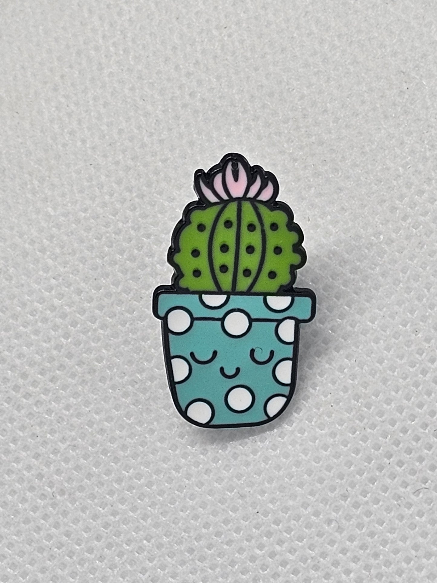 Cute cactus pin badge in a polka dot pot, ideal for accessorizing bags or jackets.