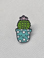Cute cactus pin badge in a polka dot pot, ideal for accessorizing bags or jackets.