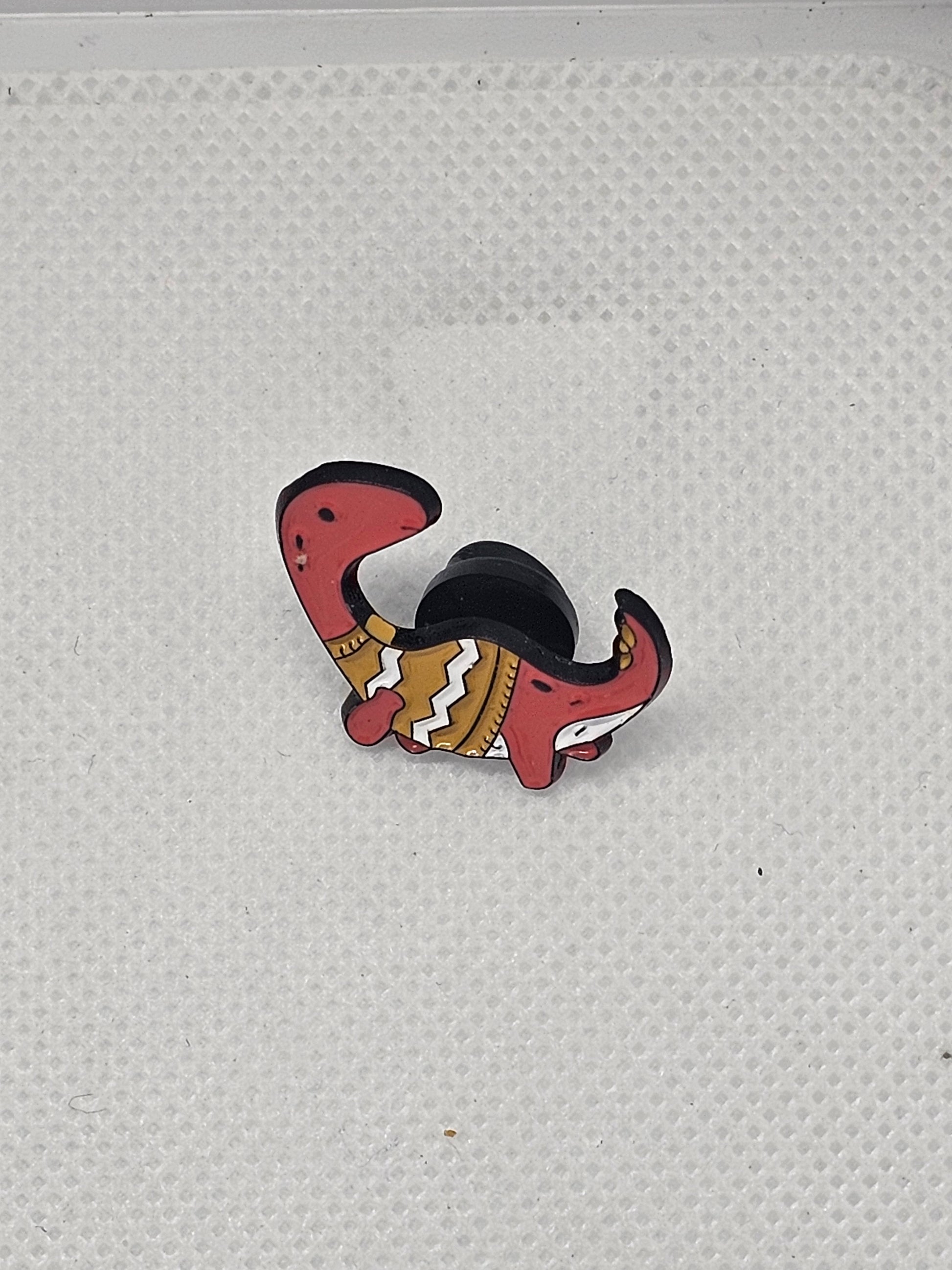Cute red dinosaur pin badge with a colorful design, perfect for clothing or bag accessories.