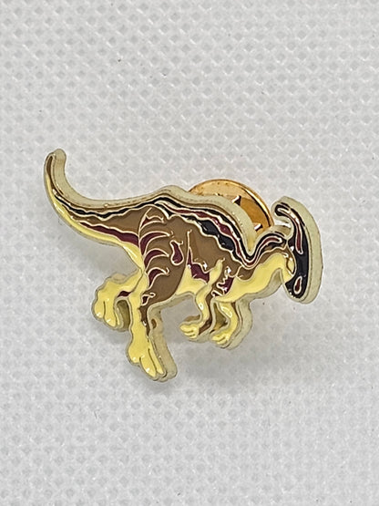 Gold dinosaur enamel pin badge, perfect accessory for dinosaur lovers, ideal for bags or clothing.