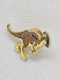 Gold dinosaur enamel pin badge, perfect accessory for dinosaur lovers, ideal for bags or clothing.