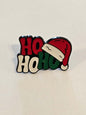 Christmas-themed badge with Santa hat and 'HO HO HO' text on a beige background