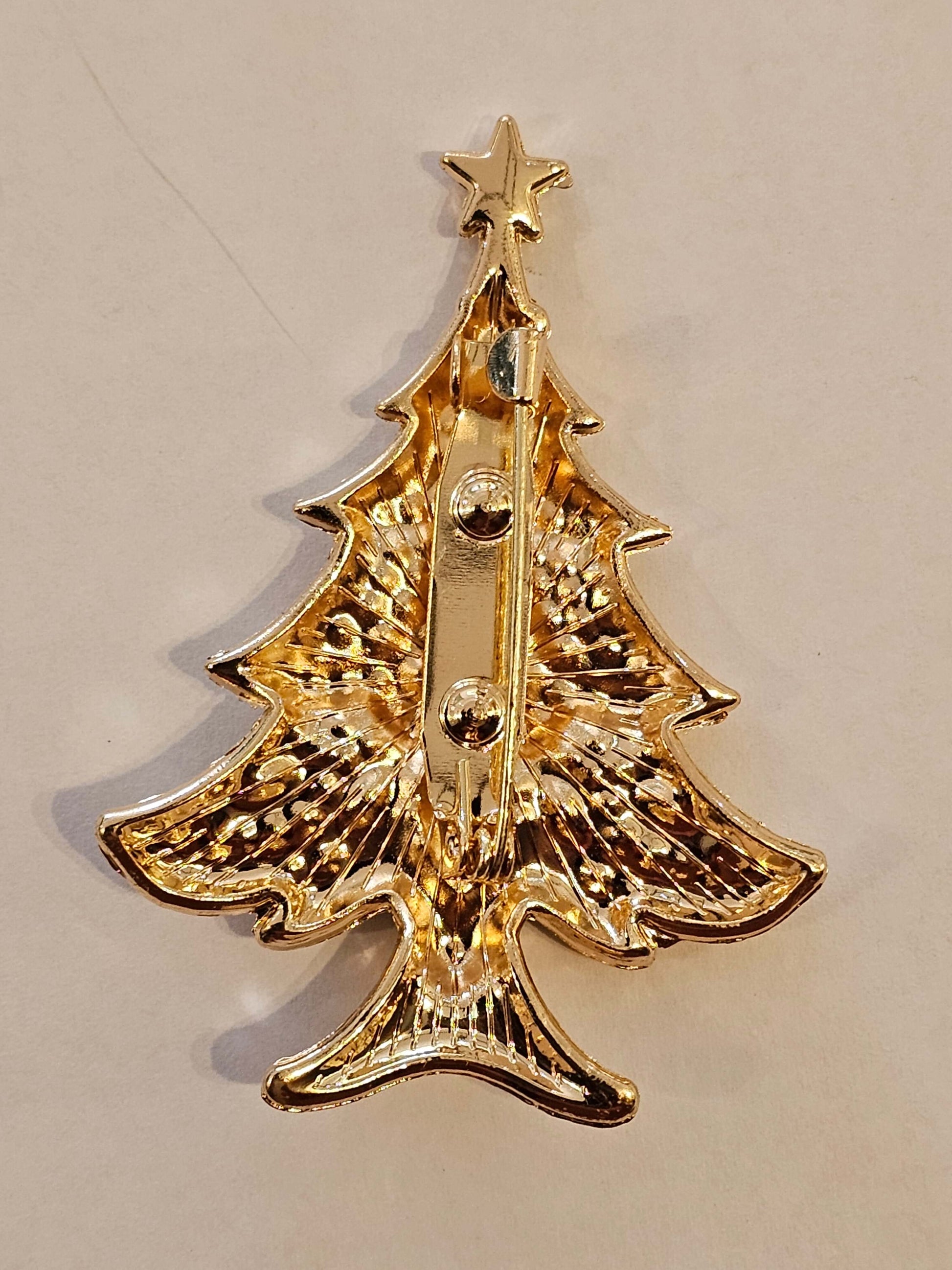 Decorative gold coloured pin on a beige background