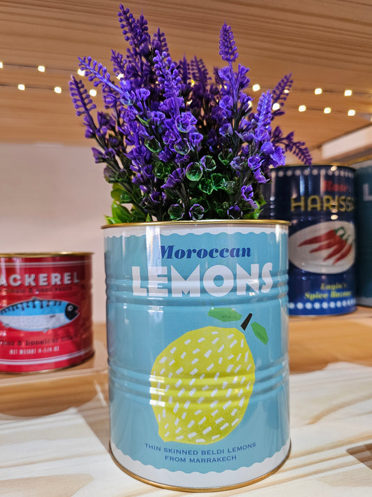 Can of 'Moroccan Lemons' with lavender flowers on a wooden surface