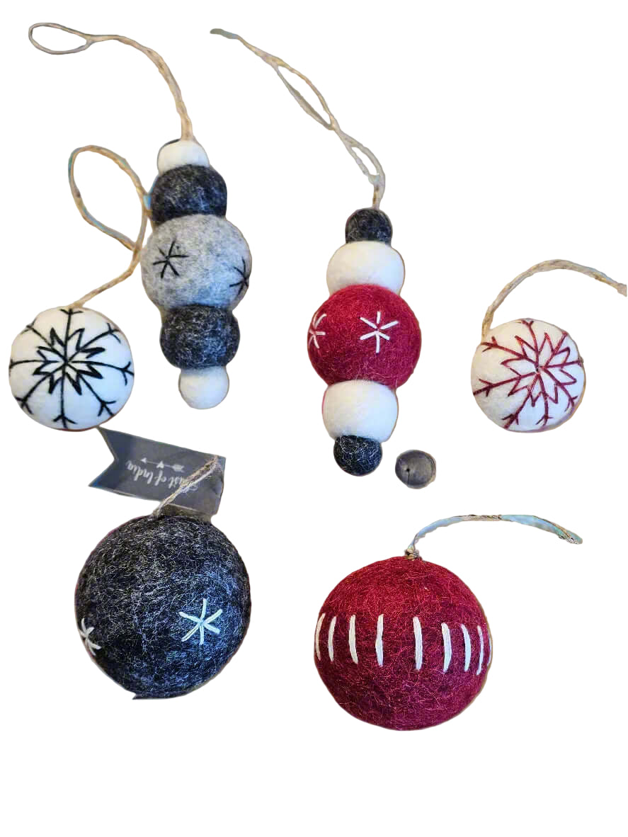 Felt ornaments with snowflake patterns on a blurred natural background