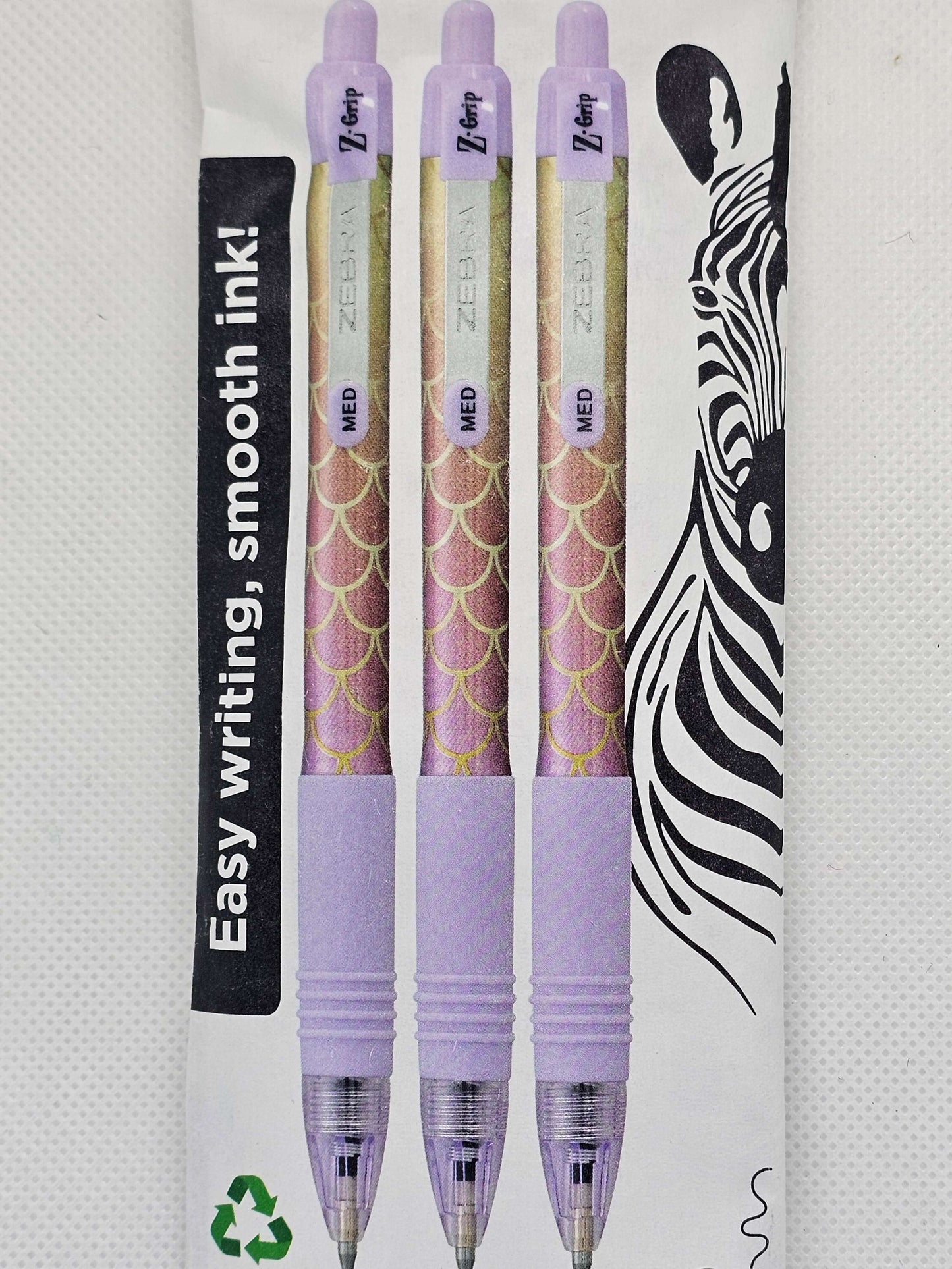 Purple pens with zebra pattern on a white background