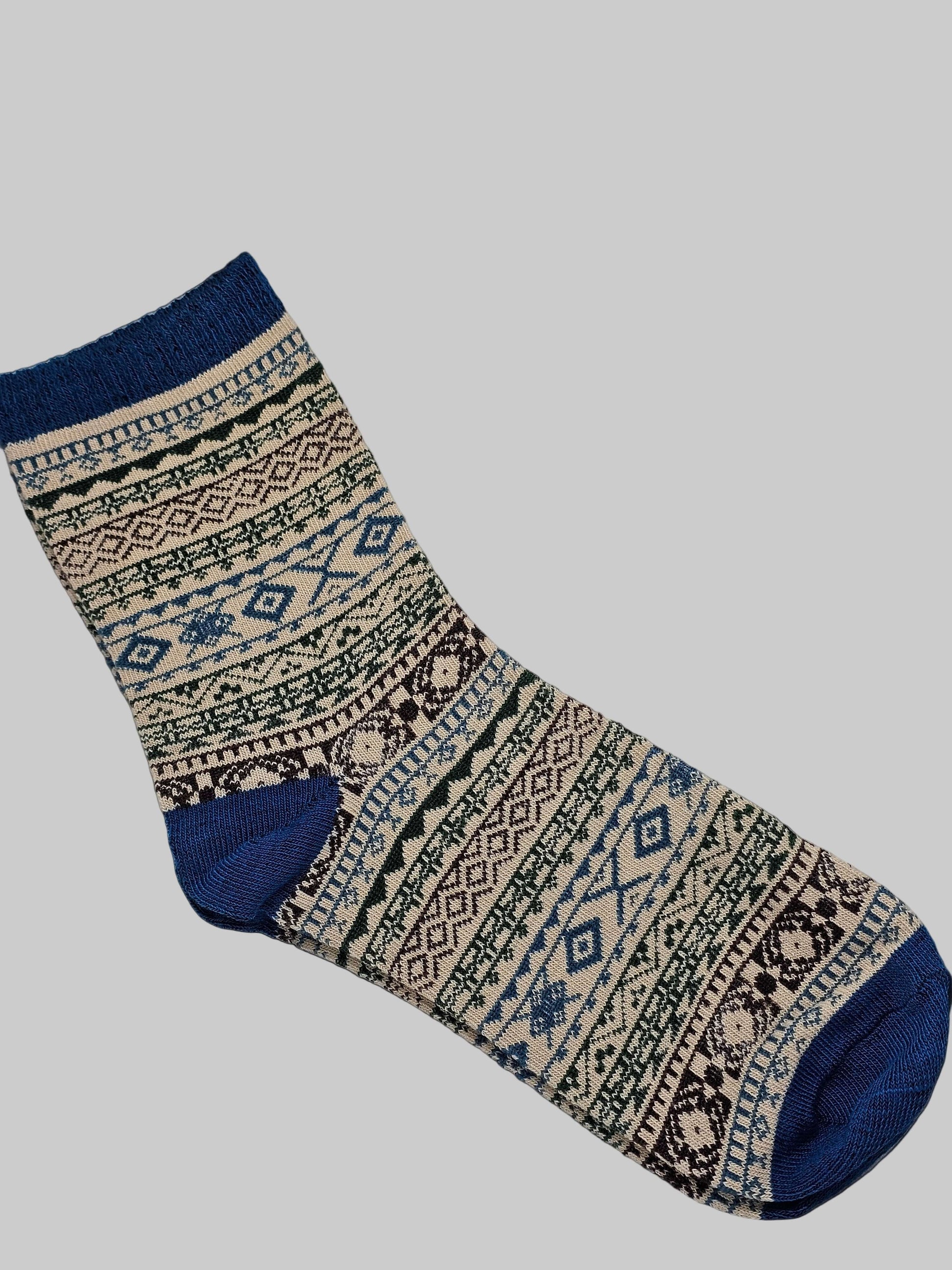 Patterned sock with blue accents on a white surface