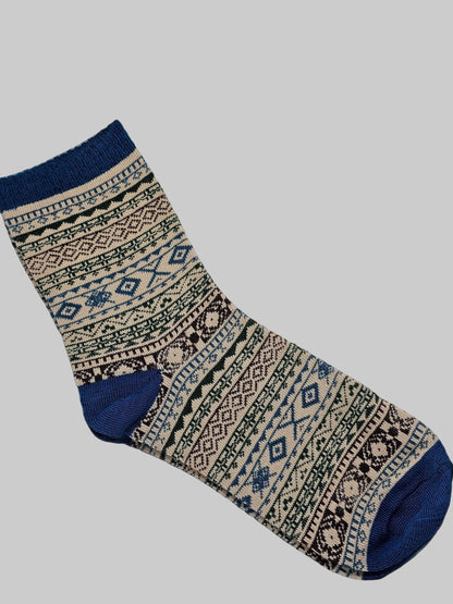 Patterned sock with blue accents on a white surface