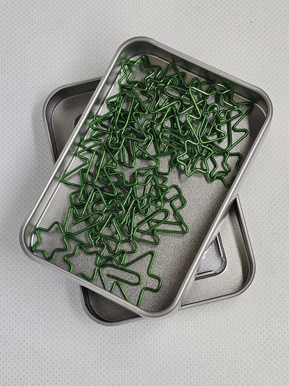 Metal tray with green star-shaped objects on a light gray background