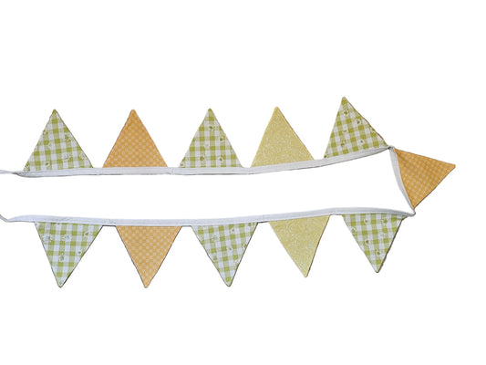 Fabric banner with checkered and solid triangles on a wooden surface