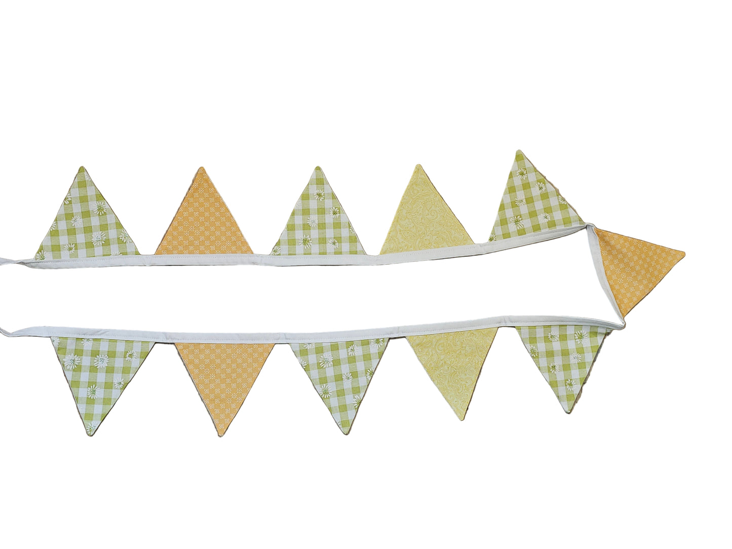 Fabric triangle banner with green and yellow checkered pattern on a wooden surface