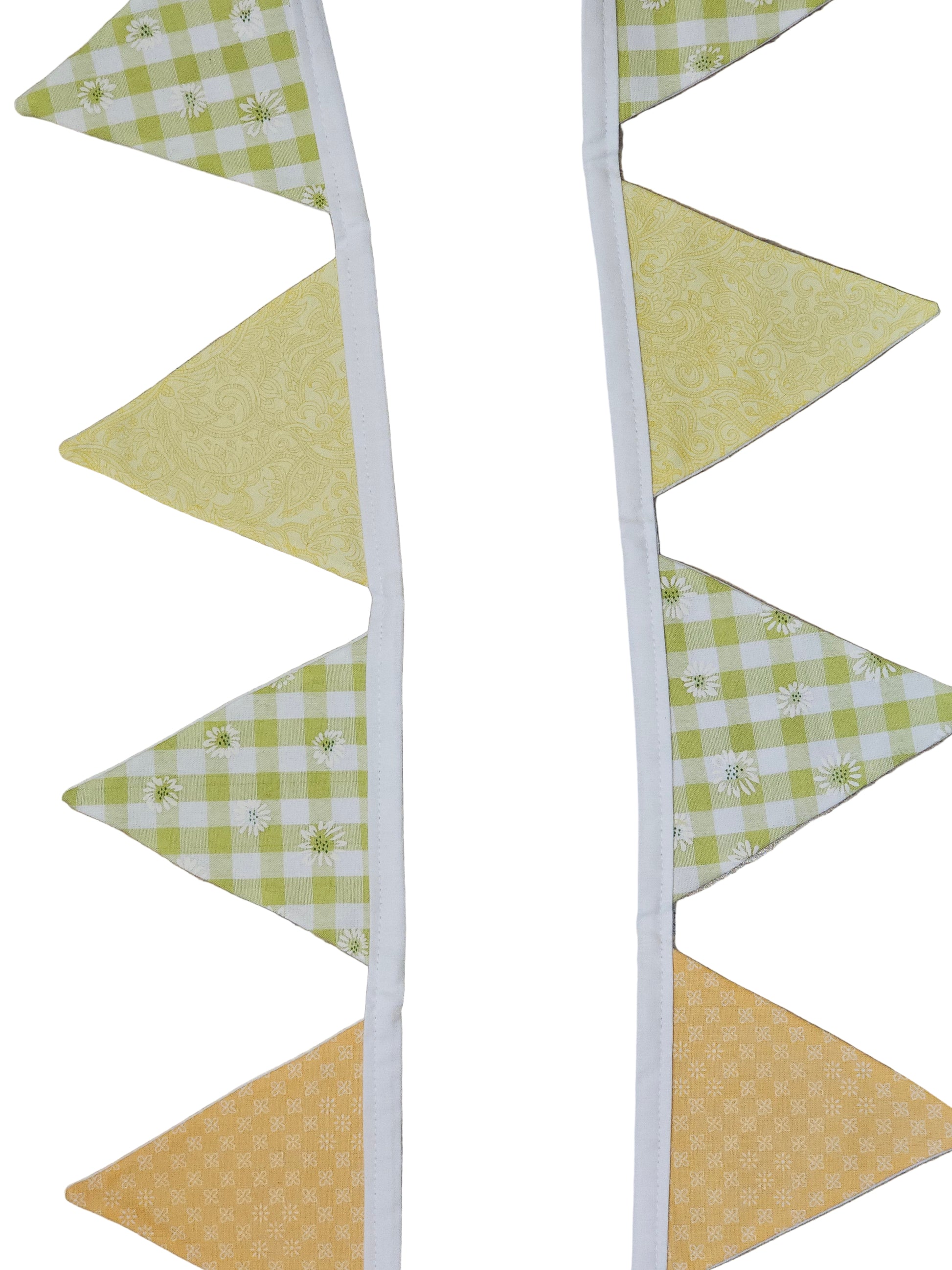 Fabric triangle banner with green and yellow checkered pattern on a wooden surface