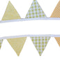 Fabric triangle banner with yellow and green patterns on a wooden background