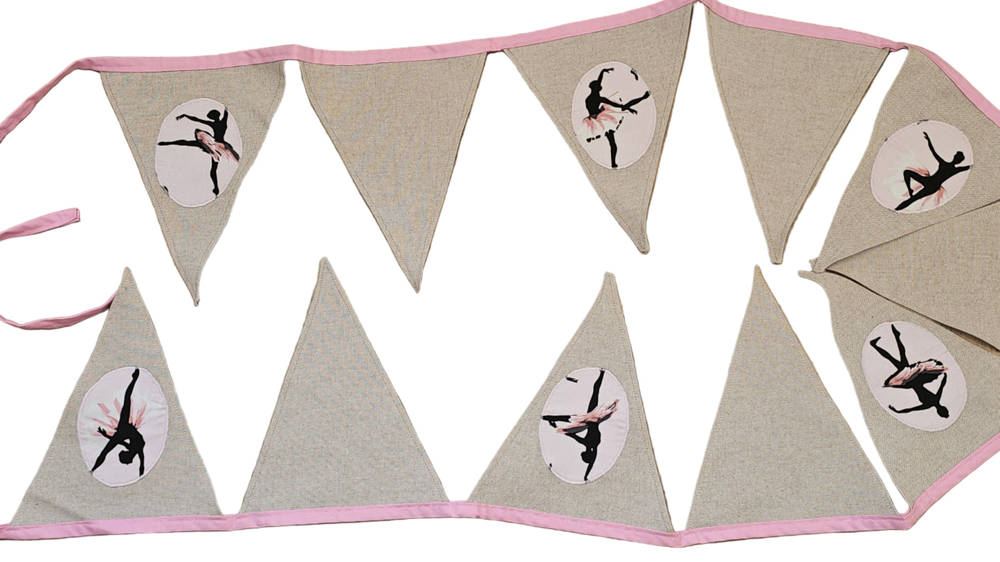 Bunting flag with a ballerina design on a wooden surface