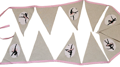 Bunting flag with a ballerina design on a wooden surface
