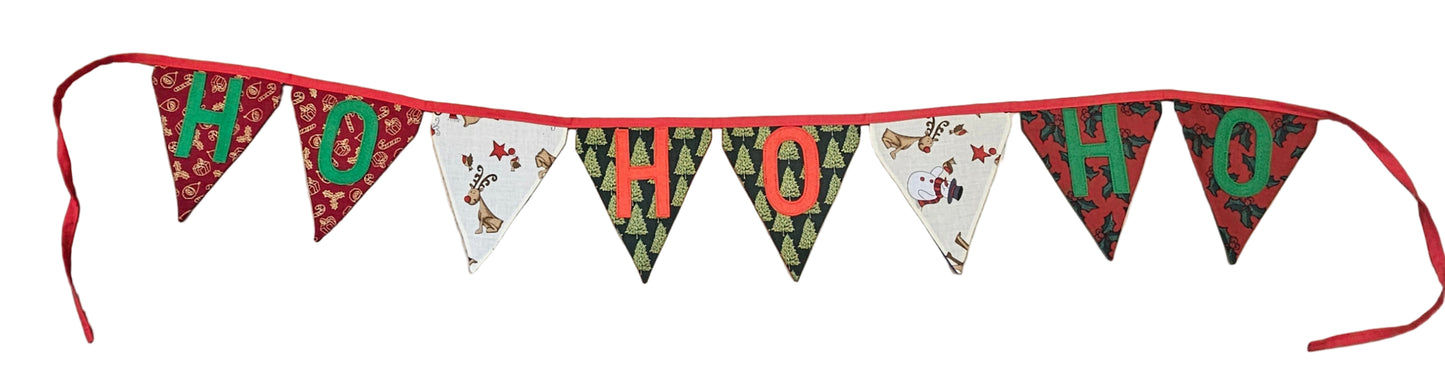 Christmas-themed banner with 'HO HO HO' on a wooden floor.