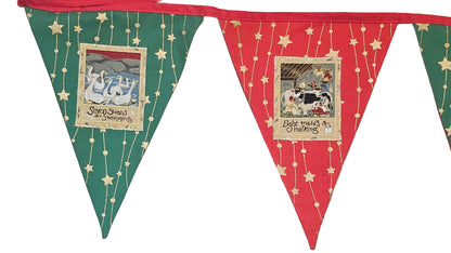 Decorative bunting with red and green triangles on a wooden surface