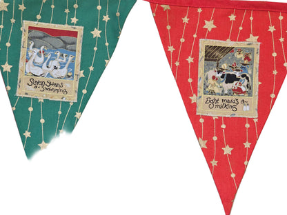 Two triangular fabric flags with illustrations and text on a wooden surface.