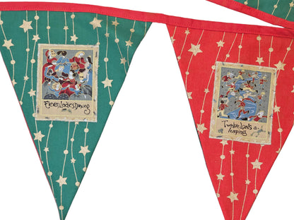 Bunting flags with festive designs and text on a wooden surface