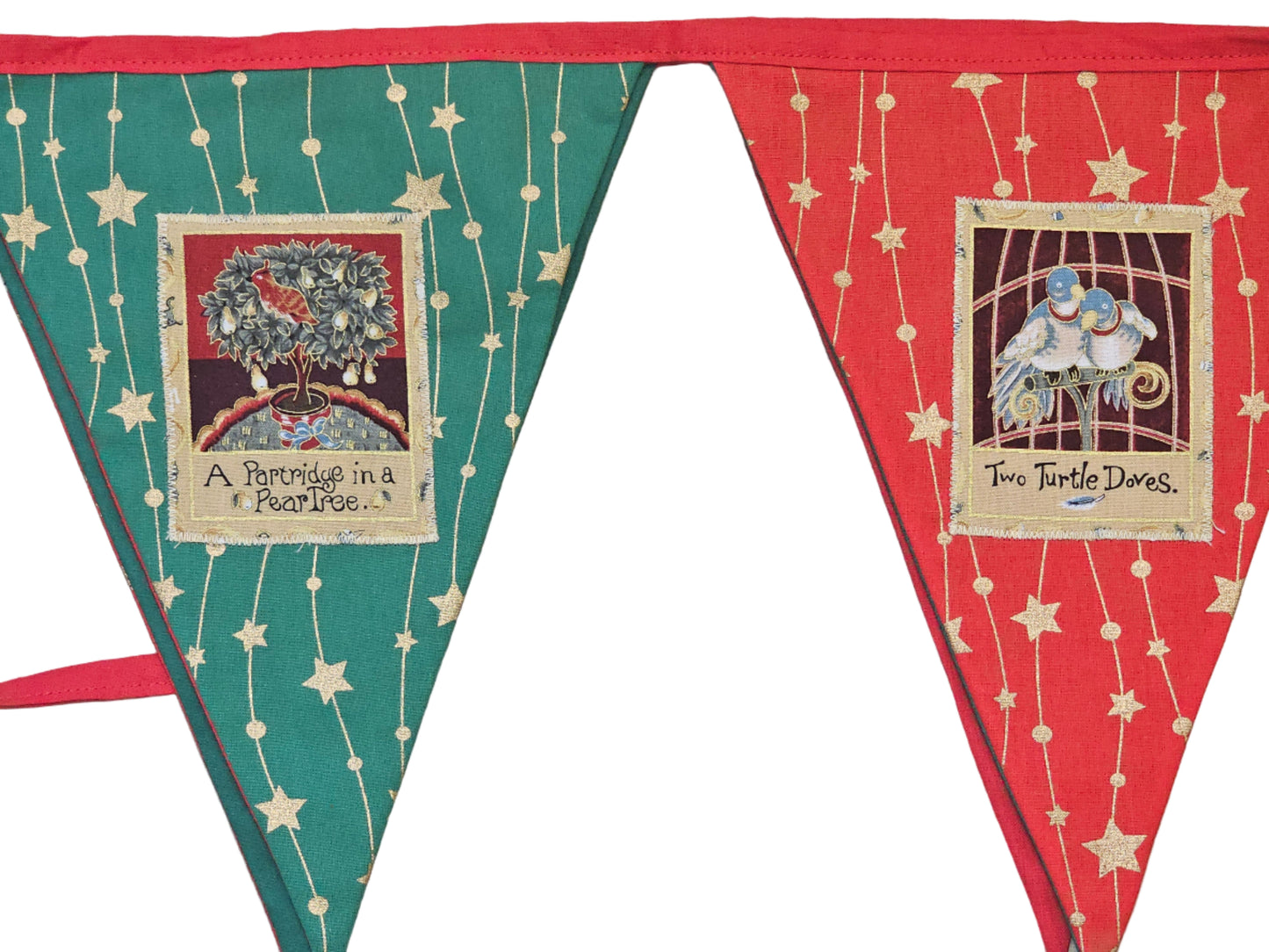 Decorative bunting with triangular flags featuring text and images on a wooden surface.