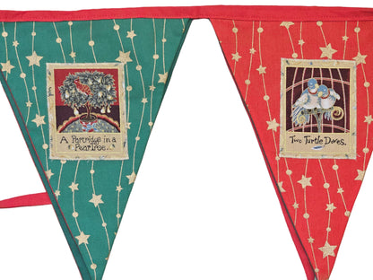 Decorative bunting with triangular flags featuring text and images on a wooden surface.