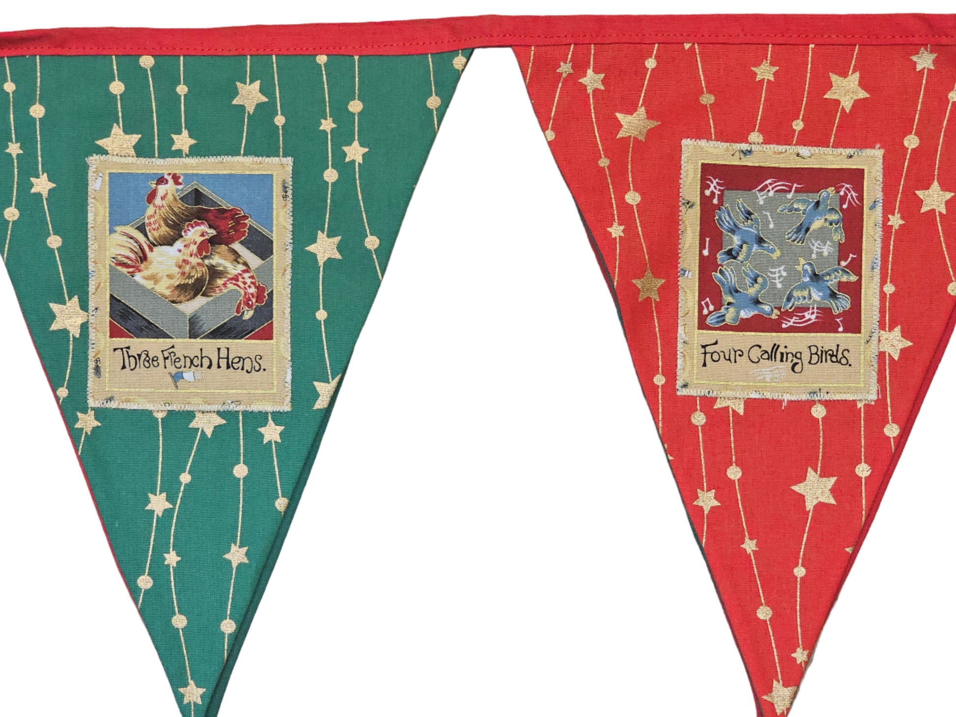 Two fabric pennants with printed designs on a wooden surface