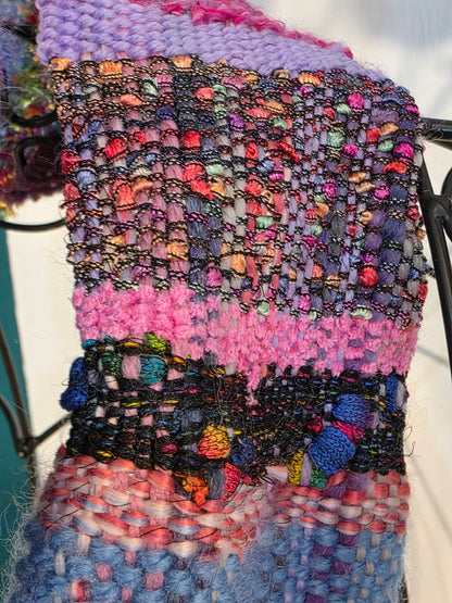 Multicolored textured fabric with a mix of pink, purple, and blue hues.