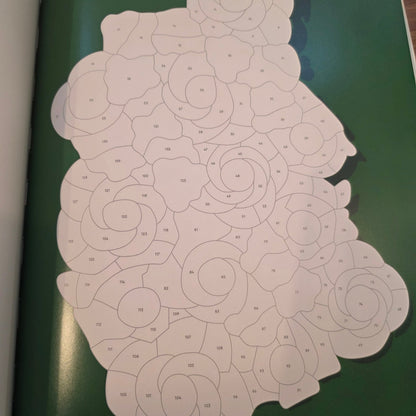 White paper with geometric pattern on a green surface