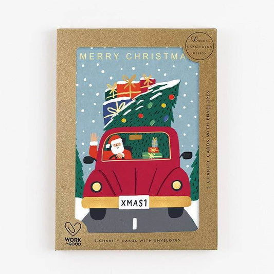 Pack of Christmas cards with a red car carrying a Christmas tree and Santa Claus, on a white background.