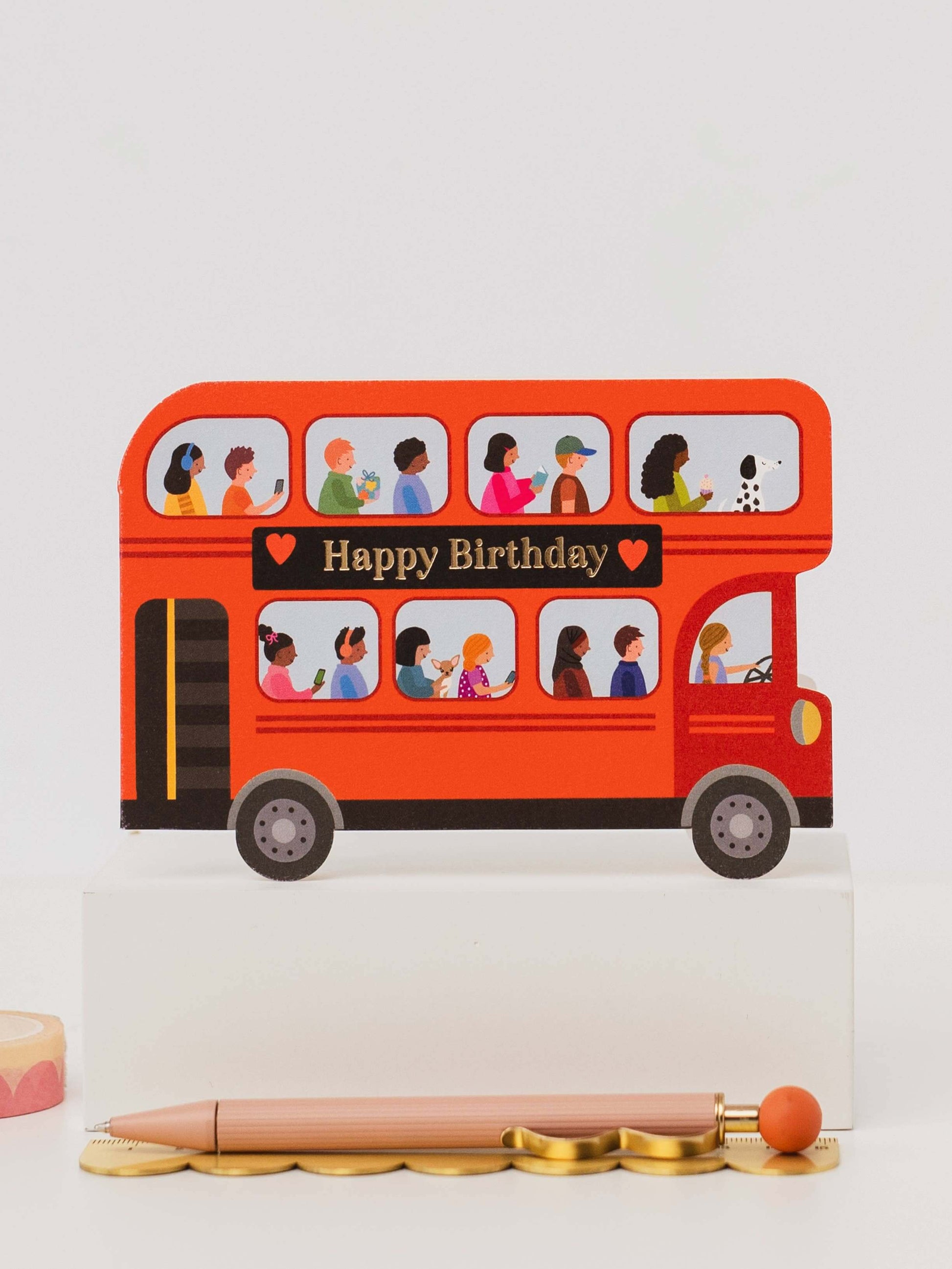Birthday card with a red double-decker bus design on a white background
