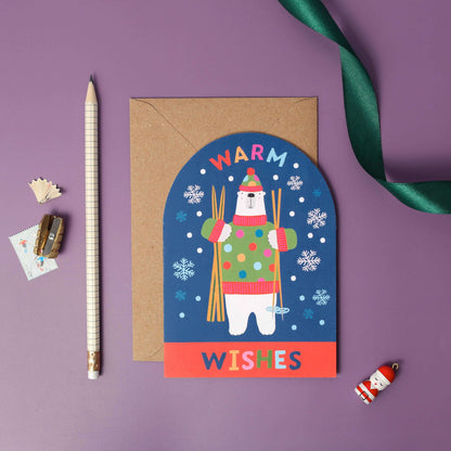 Greeting card with a polar bear illustration and 'Warm Wishes' text on a purple background.