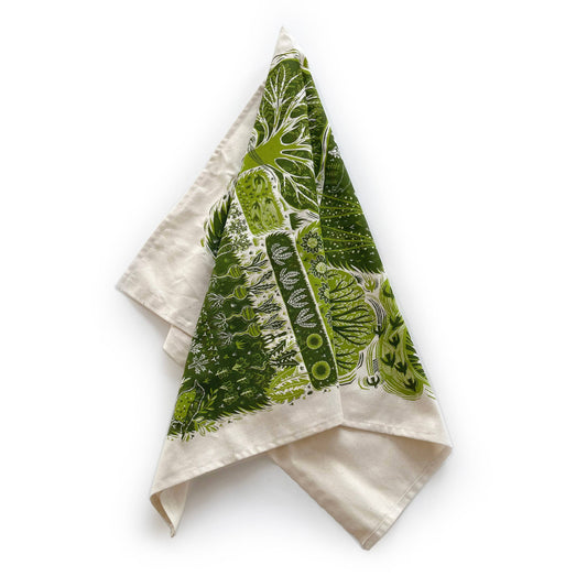 Folded towel with green leaf pattern on a white background