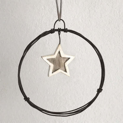 Star-shaped pendant on a black cord against a light gray background