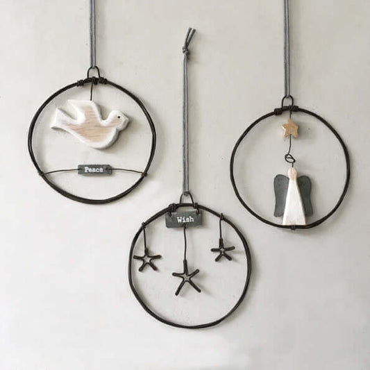 Three decorative hanging items with birds and stars on a plain background