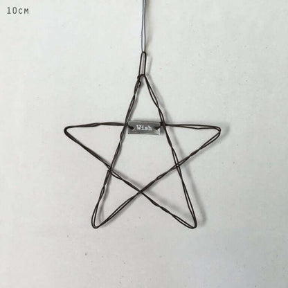 Wire star ornament with 'Wish' tag on a light gray background