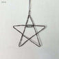 Wire star ornament with 'Wish' tag on a light gray background
