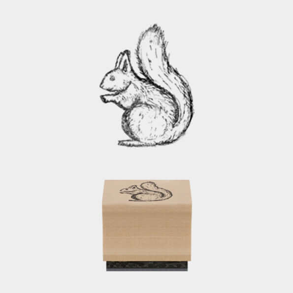 Wooden stamp with a squirrel design on a white background