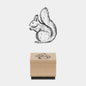Wooden stamp with a squirrel design on a white background