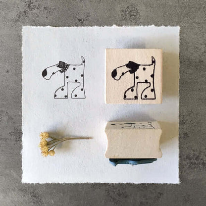 Two rubber stamps with a dog design on a white square of paper.