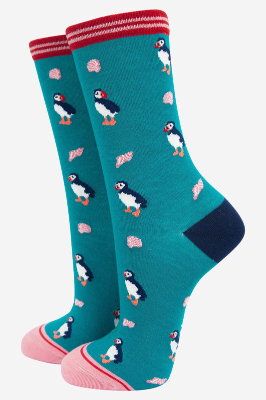 Teal socks with puffin pattern on a white background