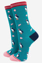 Teal socks with puffin pattern on a white background