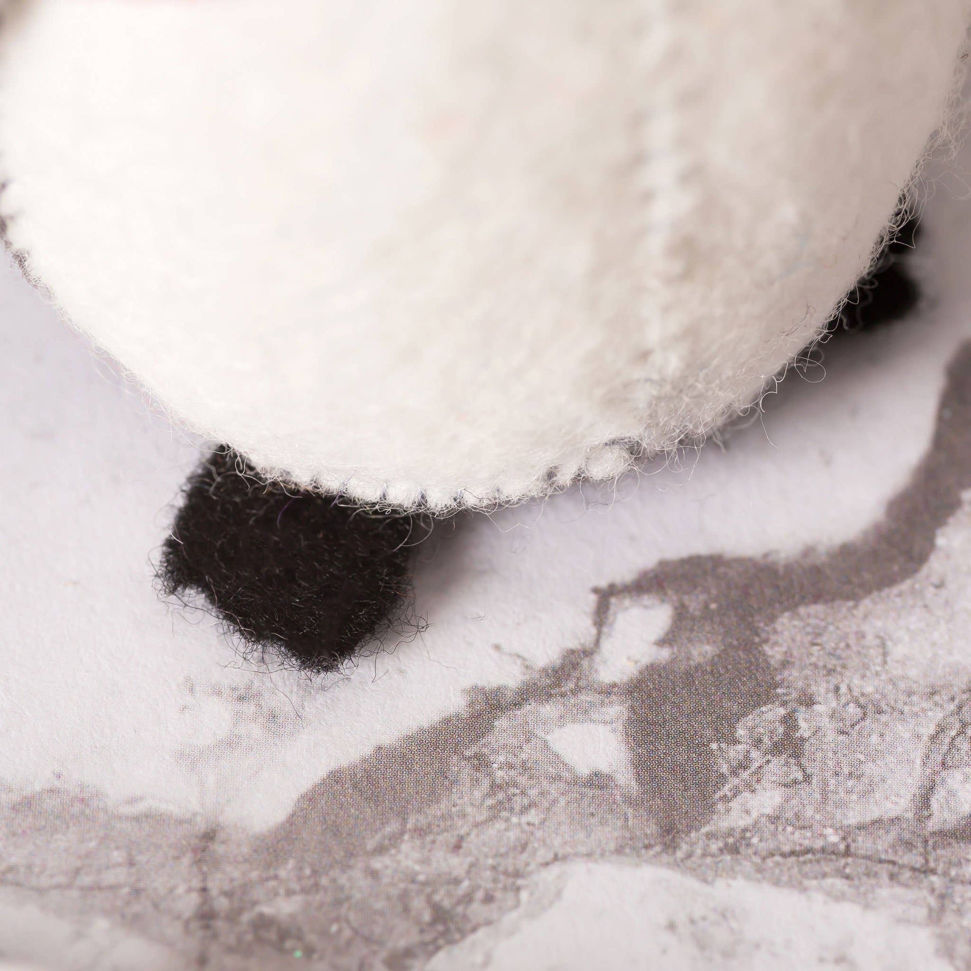 Close-up of a white and black textured object on a gray background