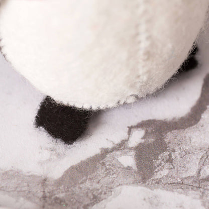 Close-up of a white and black textured object on a gray background
