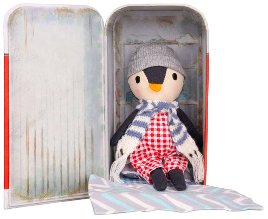 Stuffed penguin toy in a tin box with a decorative interior