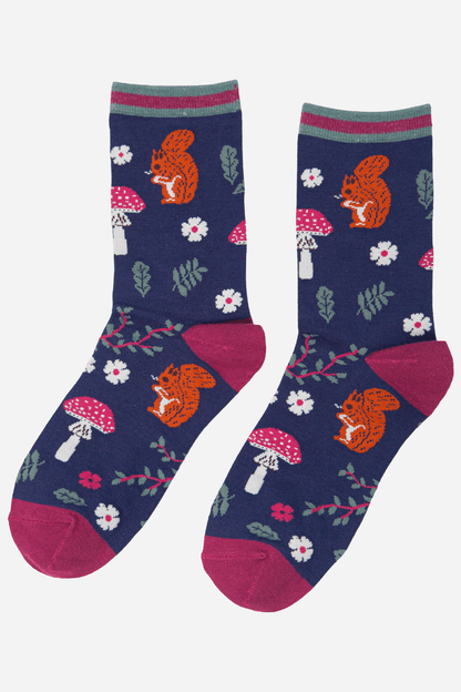 Pair of socks with squirrel and mushroom design on a blue background