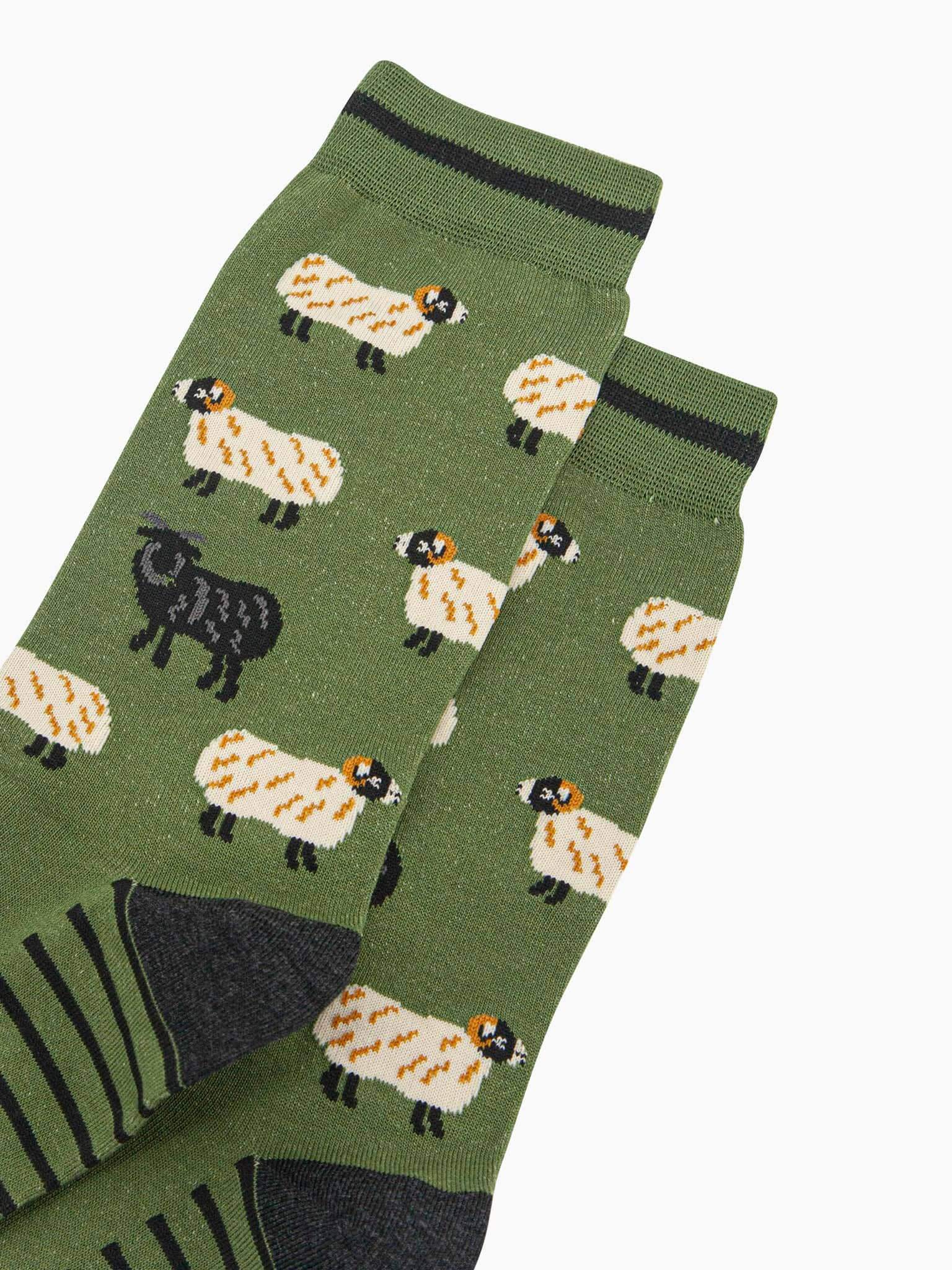 Green socks with sheep pattern on a white background