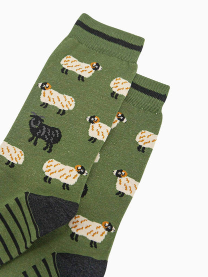 Green socks with sheep pattern on a white background