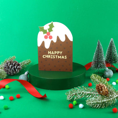 Christmas-themed card with a pudding design and 'Happy Christmas' text, surrounded by festive decorations on a green background.